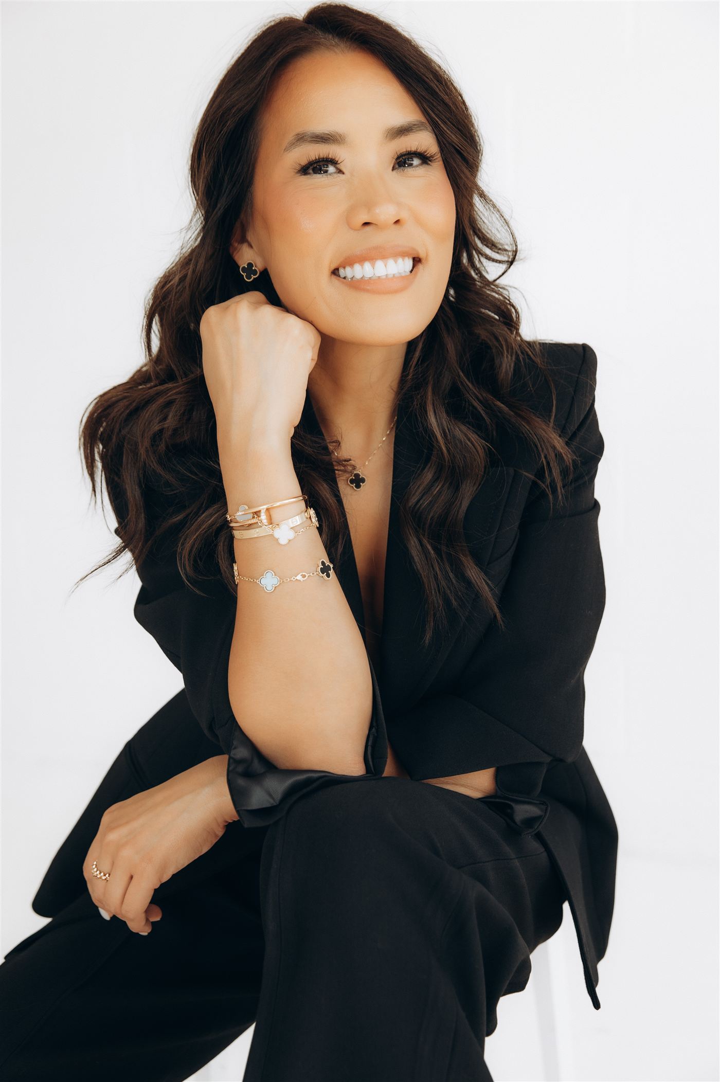 Anna Hong, smiling, resting her chin on her hand
